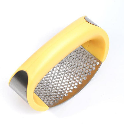 Yellow garlic press on a white background