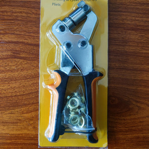 Riveting and eyelet combined pliers in packaging on a wooden surface