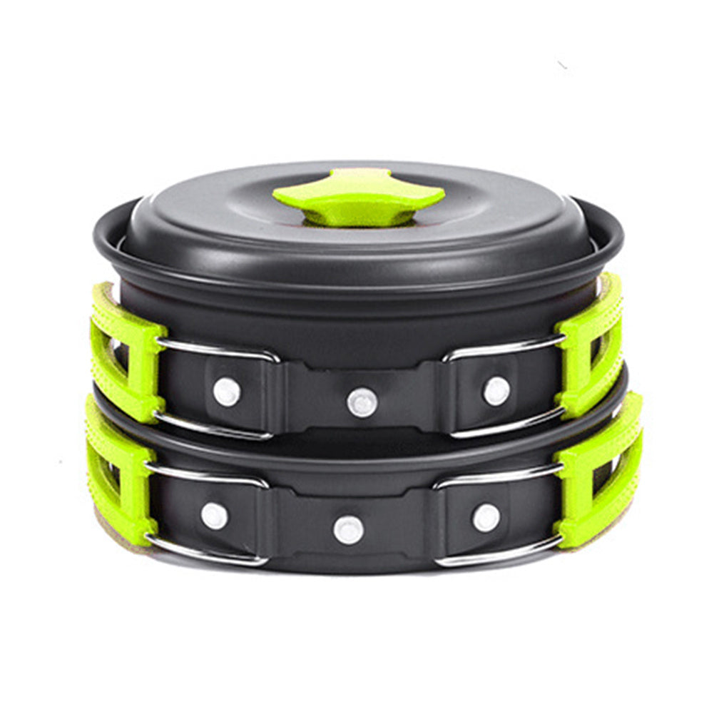 Stack of black and green cookware with a lid on a white background