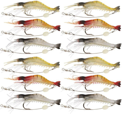 Twelve fishing shrimp lures arranged in a 4-by-3 grid on a plain white background. The lures vary in color between yellow, red, orange, and gray, each with a treble hook and split bead tail.