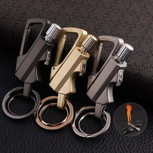1.FireMate™ Three keychain lighters in black, gold, and silver on a textured dark background.