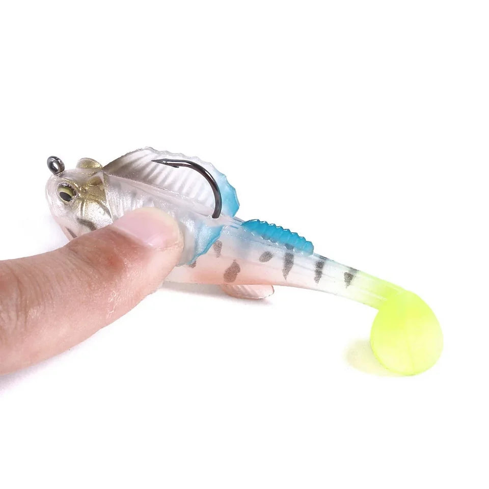 Transparent fishing lure with a hook, held by a finger against a white background