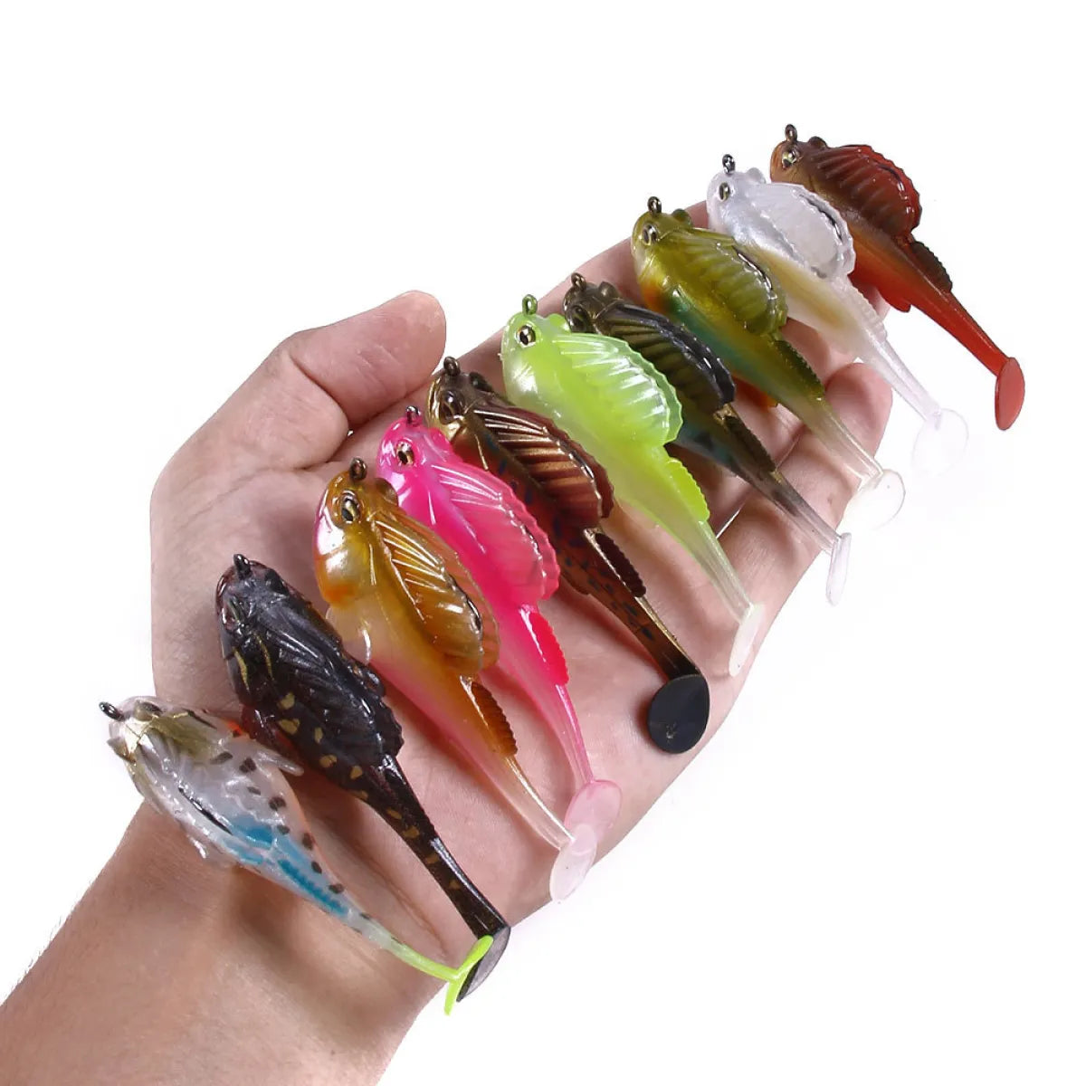 Hand holding a variety of colorful fishing lures against a white background